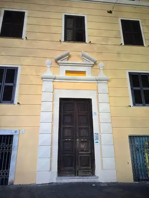 a building with a wooden door and two windows at TP Apartment Luxury Colosseum in Rome