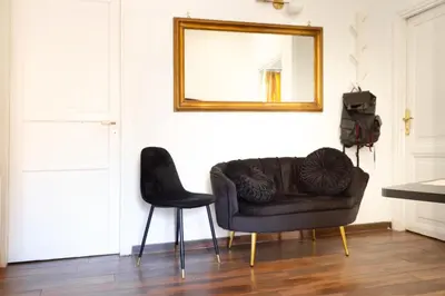 a couch and a chair in a room with a mirror at TP Apartment Luxury Colosseum in Rome