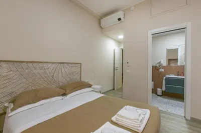 a bedroom with a large bed and a bathroom at Borgo Vittorio 20 Vatican Home in Rome
