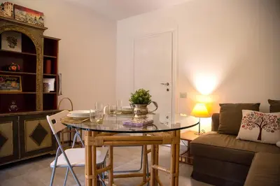 a living room with a table and a couch at Aventino apartment in Rome