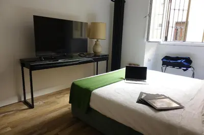 a bedroom with a bed with a laptop on it at Piccolo Principe Suite in Rome