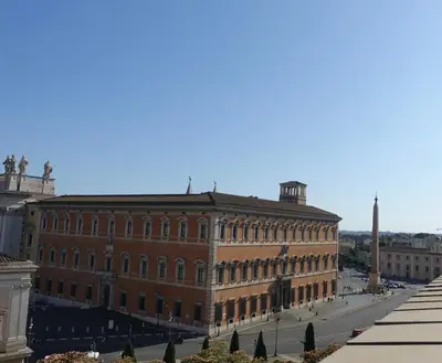 a large brick building with a street in front of it at Piccolo Principe Suite in Rome
