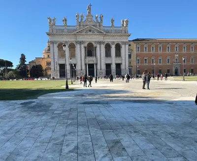 a large building with people walking in front of it at Piccolo Principe Suite in Rome