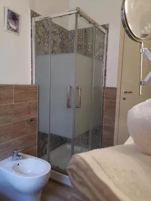 a bathroom with a shower with a toilet and a sink at Appartamento di Sara in Rome