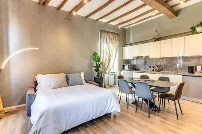 a bedroom with a bed and a table and chairs at Castel Sant'Angelo SuiteLux in Rome