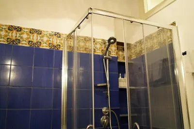 a shower with a glass door in a bathroom at Appartamento Roma centro in Rome