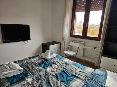a bedroom with a bed with towels on it at ST. PETER'S ROOMS SUITE in Rome
