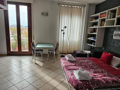 a living room with a bed and a table and a desk at ST. PETER'S ROOMS SUITE in Rome
