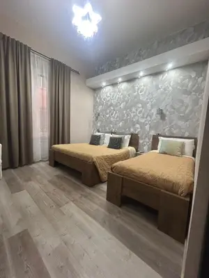 a bedroom with two beds and a wall at Vanella Rome Domus in Rome