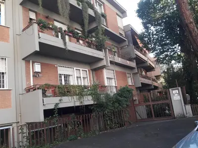 an apartment building with plants on the balconies at Rizzola casa e appartamento per vacanze in Rome