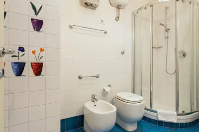a bathroom with a toilet and a shower at Barberini 360 in Rome