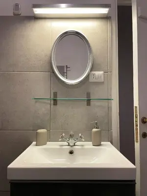 a bathroom with a sink and a mirror at Historical Central Rome Flat in Rome