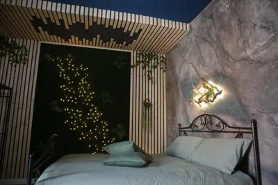 a bedroom with a bed with a christmas tree on the wall at Roma Imperial Suites in Rome