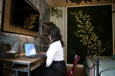 a woman sitting at a desk with a laptop at Roma Imperial Suites in Rome