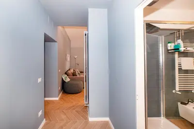 a hallway with a glass door leading to a living room at Domus Pietrae in Rome