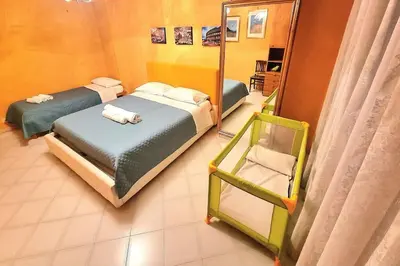 a bedroom with two beds and a mirror at Appartamento Antico AMOR in Rome