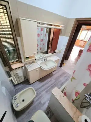 a bathroom with a sink and a toilet and a mirror at Appartamento Antico AMOR in Rome