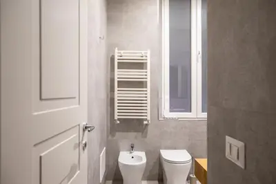 a small bathroom with a toilet and a window at Corso Caesar Suites in Rome