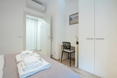 a bedroom with a bed with white towels on it at Emily Valles Apartment Saint Peter's in Rome