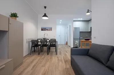 a living room with a table and chairs and a couch at Emily Valles Apartment Saint Peter's in Rome