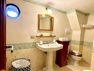 a bathroom with a sink and a toilet at Colosseum Luxury Apartment in Rome