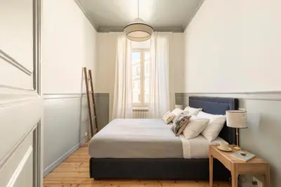 a bedroom with a bed with a table and a window at Elegante Dimora a Trastevere in Rome