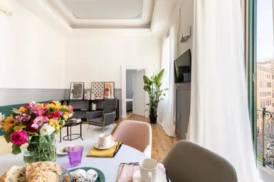 a living room with a table with flowers on it at Elegante Dimora a Trastevere in Rome