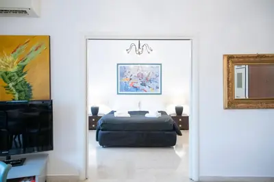 a bedroom with a bed and a tv and a mirror at San Peter Terrace View in Rome