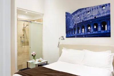 a bedroom with a king sized bed and a shower at Via Del Corso Home Roma in Rome