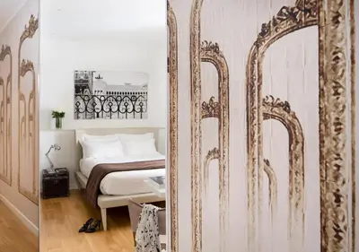 a bedroom with a large mirror next to a bed at Via Del Corso Home Roma in Rome