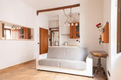 a living room with a white couch and a table at Elegant & Quiet Apartment next to Colosseo in Rome