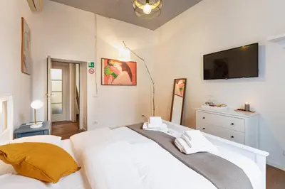 a bedroom with a bed and a tv on the wall at La Locanda Bertani in Rome
