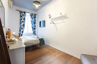 a small bedroom with a bed and a desk at La Locanda Bertani in Rome