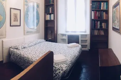 a small bedroom with a bed and a window at A Place in Prati in Rome