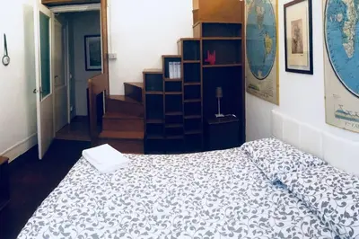 a bedroom with a bed and a book shelf at A Place in Prati in Rome
