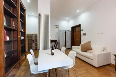a living room with a white table and a couch at Passeggiata al Vaticano in Rome