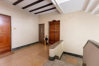 an empty room with a hallway with a wooden door at Passeggiata al Vaticano in Rome