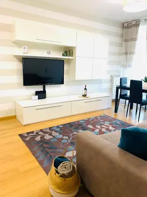 a living room with a couch and a flat screen tv at PortamiPortese Trastevere Terrace in Trastevere