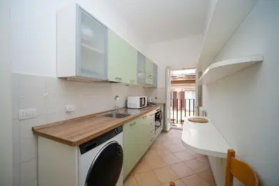 a kitchen with a sink and a washing machine at Elisa's Trevi Fountain BuddyRent in Rome