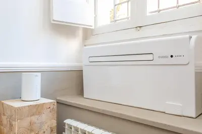 a white dishwasher in a kitchen next to a window at Central Charm near Piazza Navona - Cozy Loft for 2 in Rome