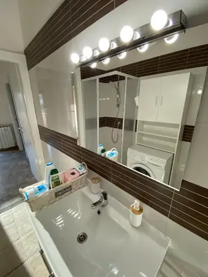 a bathroom sink with a mirror and a washing machine at CASA BALU' in Rome