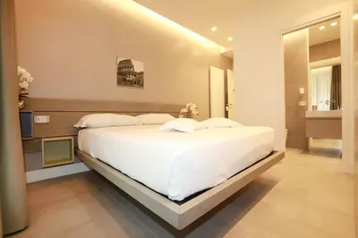 a bedroom with a large white bed in a room at Unique Luxury Stay in Rome