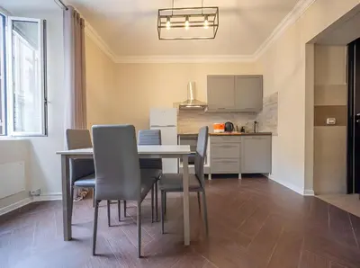 a kitchen and dining room with a table and chairs at Ghetto BuddyRent in Rome