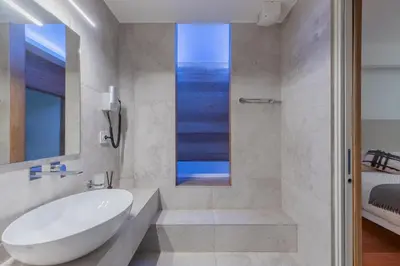 a bathroom with a white tub and a sink at Saint Peter Caesar Suites in Rome