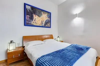 a bedroom with a bed and a painting on the wall at Clemente XII Al Quirinale House in Rome