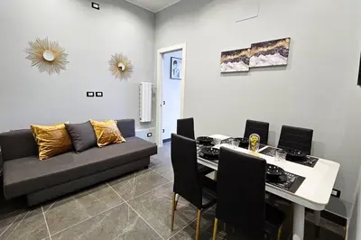 a living room with a couch and a table at Domitia Vatican Luxury Apartment in Rome