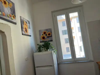 a kitchen with a window and a refrigerator with a plant on it at Appartamento Residenza Girasole Vatican in Rome