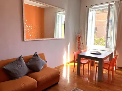 a living room with a couch and a table at Appartamento Residenza Girasole Vatican in Rome