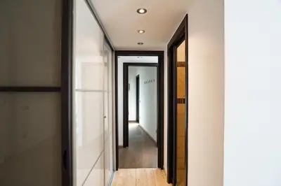 a hallway with a mirror and a hallway leading into a room at Gabbo - House in Rome