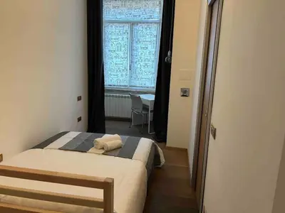 a small bedroom with a bed and a window at Gabbo - House in Rome
